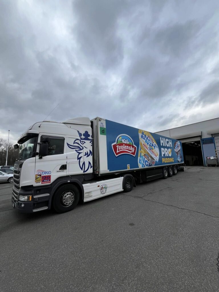 Náves s reklamným polepom 2,5 × 12 m zaparkovaný na parkovisku
